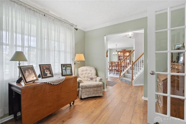 2866 Fence Stone Ct, Dayton, OH 45458 - living area with wood-type flooring, a chandelier, ornamental molding, stairs, and baseboards