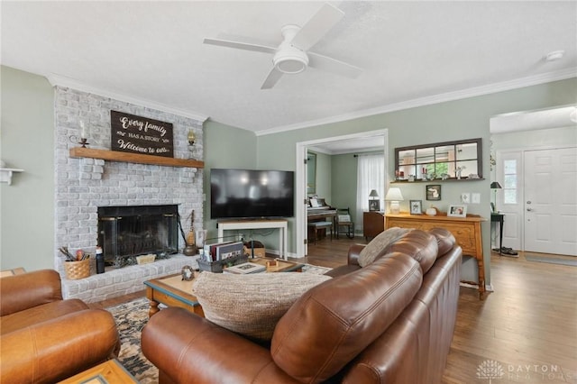 2866 Fence Stone Ct, Dayton, OH 45458 - living area with wood finished floors, crown molding, a ceiling fan, and a brick fireplace