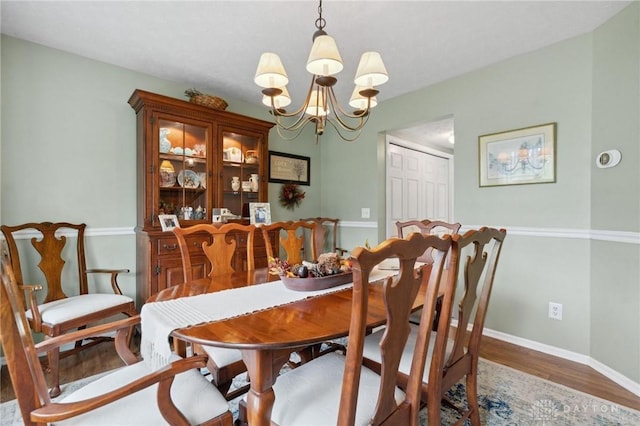2866 Fence Stone Ct, Dayton, OH 45458 - dining area with a chandelier, wood finished floors, and baseboards