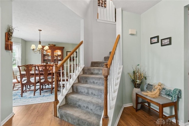 2866 Fence Stone Ct, Dayton, OH 45458 - staircase with wood finished floors, a chandelier, and baseboards