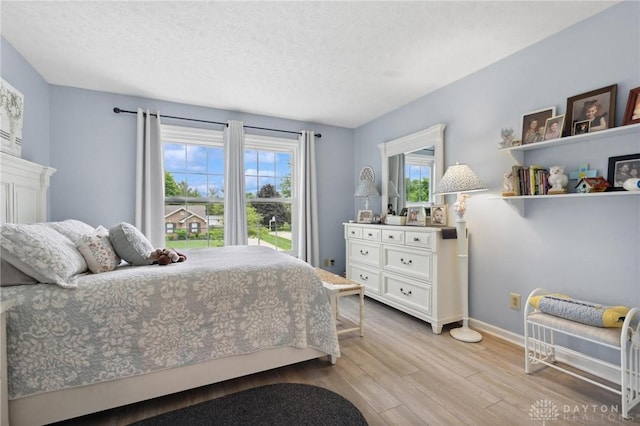 2866 Fence Stone Ct, Dayton, OH 45458 - bedroom featuring light wood-style flooring, baseboards, and a textured ceiling
