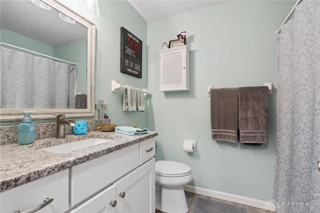 2866 Fence Stone Ct, Dayton, OH 45458 - bathroom featuring vanity, toilet, wood finished floors, and baseboards