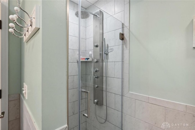 2866 Fence Stone Ct, Dayton, OH 45458 - full bathroom featuring a tile shower and a wainscoted wall