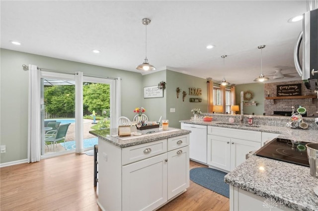 2866 Fence Stone Ct, Dayton, OH 45458 - kitchen with dishwasher, a sink, light wood finished floors, white cabinets, and hanging light fixtures