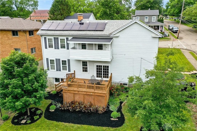 397 Chapman St, Waynesville, OH 45068 - rear view of property with solar panels, a deck, roof with shingles, and a chimney