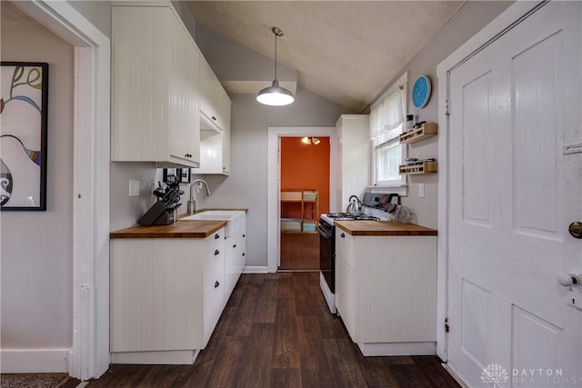 397 Chapman St, Waynesville, OH 45068 - kitchen featuring gas range, wooden counters, a sink, vaulted ceiling, and dark wood finished floors
