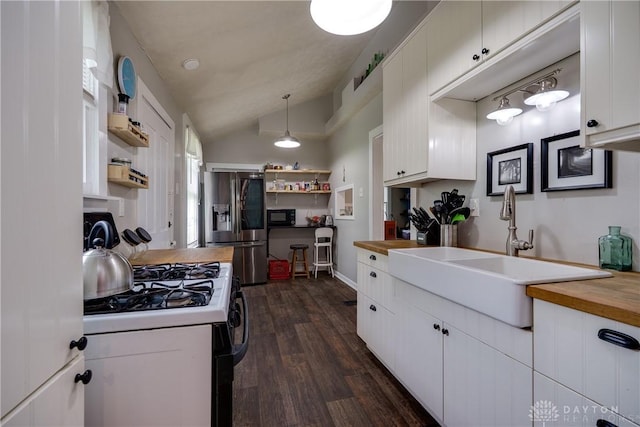397 Chapman St, Waynesville, OH 45068 - kitchen featuring gas range, stainless steel fridge with ice dispenser, lofted ceiling, wooden counters, and white cabinets
