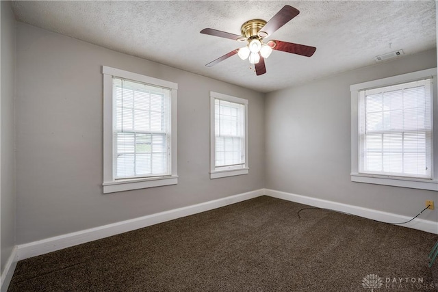 397 Chapman St, Waynesville, OH 45068 - spare room featuring dark carpet, baseboards, a textured ceiling, and a ceiling fan