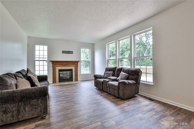 510 Delaware Xing, Trenton, OH 45067 - living room featuring a textured ceiling, dark wood-style floors, baseboards, and a tiled fireplace