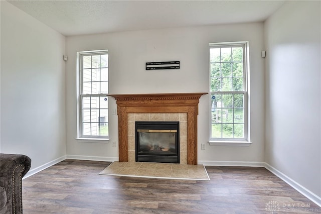 510 Delaware Xing, Trenton, OH 45067 - unfurnished living room with plenty of natural light, wood finished floors, and a tiled fireplace