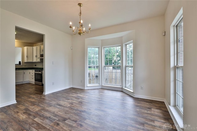510 Delaware Xing, Trenton, OH 45067 - empty room with a chandelier, dark wood-type flooring, and baseboards