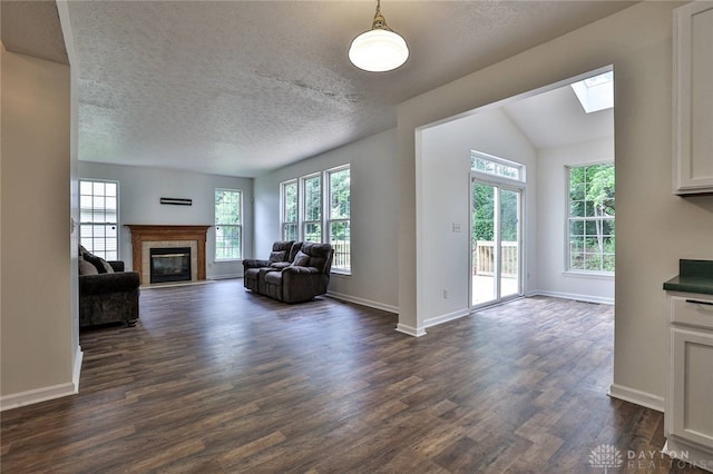 510 Delaware Xing, Trenton, OH 45067 - living room featuring a fireplace with flush hearth, dark wood-style flooring, baseboards, lofted ceiling, and a textured ceiling
