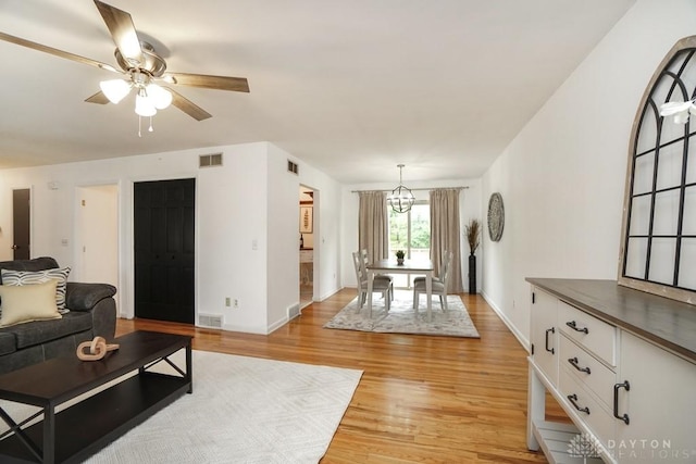 720 Boylston St, Middletown, OH 45044 - living area with light wood-style flooring, baseboards, ceiling fan, and a chandelier