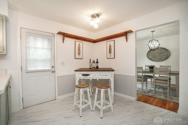 720 Boylston St, Middletown, OH 45044 - dining space featuring a chandelier and baseboards
