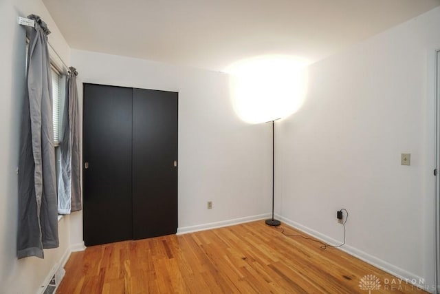 720 Boylston St, Middletown, OH 45044 - unfurnished bedroom featuring light wood finished floors, baseboards, and a closet