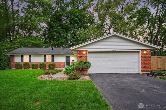 2765 Hemphill Rd, Kettering, OH 45440 - single story home featuring brick siding, driveway, and a garage