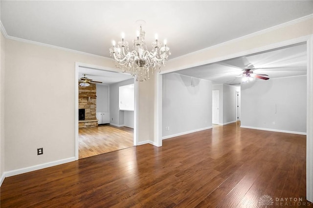 2765 Hemphill Rd, Kettering, OH 45440 - unfurnished living room with a ceiling fan, a chandelier, a fireplace, wood finished floors, and crown molding