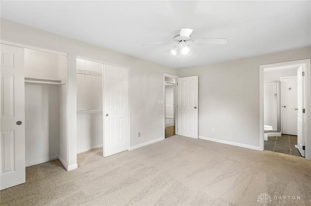 2765 Hemphill Rd, Kettering, OH 45440 - unfurnished bedroom featuring carpet floors, baseboards, connected bathroom, and ceiling fan