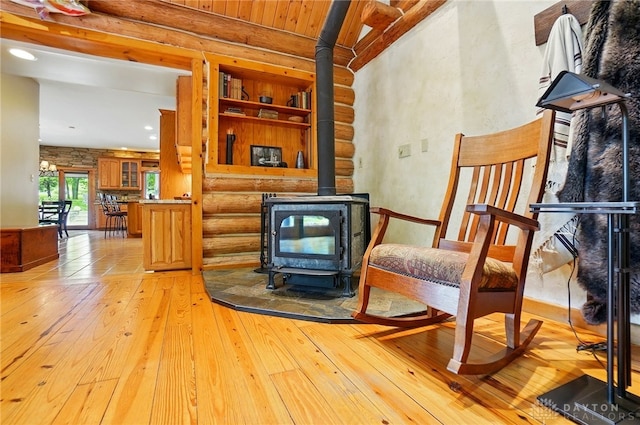 508 E Lower Springboro Rd, Clearcreek Twp, OH 45066 - sitting room with a wood stove, light wood-style floors, and rustic walls