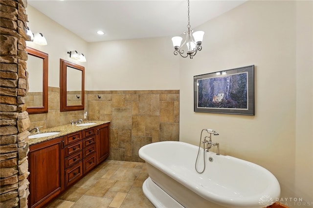 508 E Lower Springboro Rd, Clearcreek Twp, OH 45066 - bathroom featuring a freestanding tub, tile walls, double vanity, and a chandelier