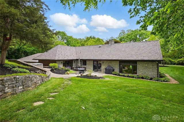 508 E Lower Springboro Rd, Clearcreek Twp, OH 45066 - rear view of property with stone siding, a lawn, and a chimney
