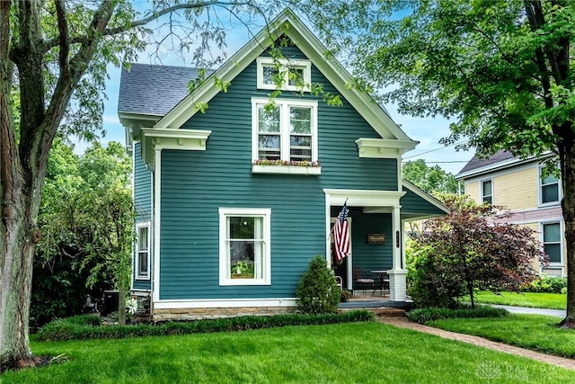206 Wright Ave, Lebanon, OH 45036 - victorian home with covered porch, a front lawn, and a shingled roof