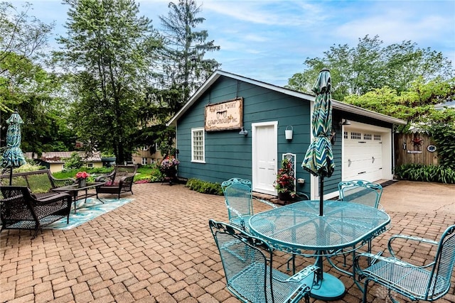 206 Wright Ave, Lebanon, OH 45036 - view of patio featuring outdoor dining space, a garage, and outdoor lounge area