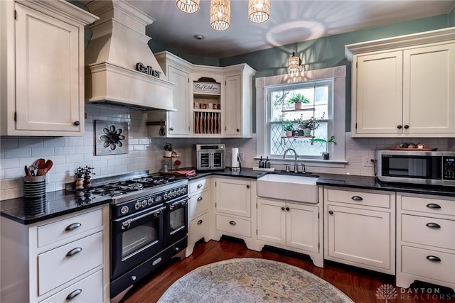206 Wright Ave, Lebanon, OH 45036 - kitchen featuring stainless steel microwave, range with two ovens, custom exhaust hood, a sink, and open shelves