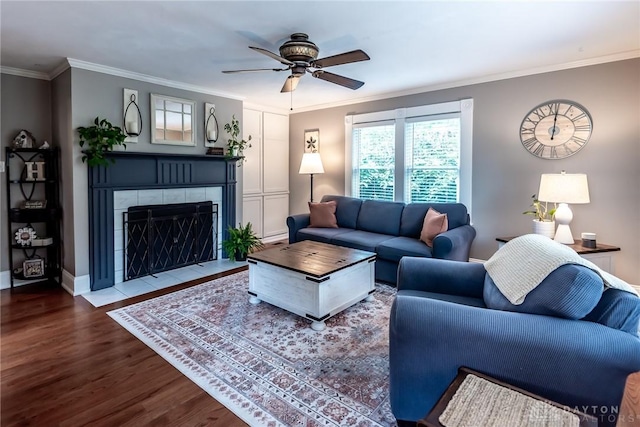 206 Wright Ave, Lebanon, OH 45036 - living area featuring a tile fireplace, wood finished floors, a ceiling fan, crown molding, and baseboards