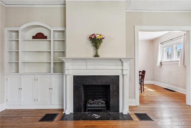 303 Hadley Ave, Oakwood, OH 45419 - detailed view of ornamental molding, wood finished floors, a fireplace, and baseboards