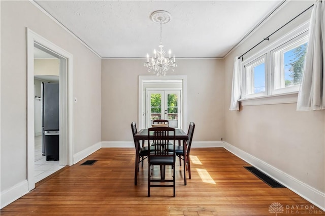 303 Hadley Ave, Oakwood, OH 45419 - dining area with a chandelier, light wood-style flooring, baseboards, and ornamental molding