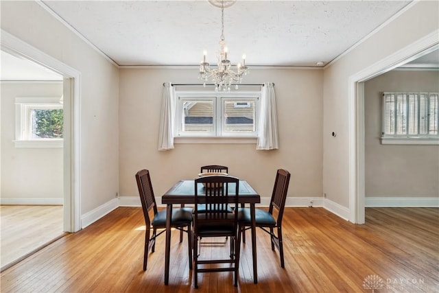 303 Hadley Ave, Oakwood, OH 45419 - dining area with a chandelier, hardwood / wood-style floors, crown molding, and baseboards