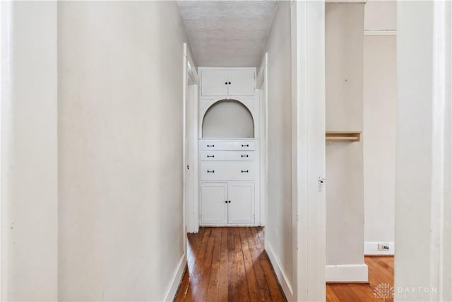 303 Hadley Ave, Oakwood, OH 45419 - hallway with hardwood / wood-style flooring, baseboards, and a textured ceiling