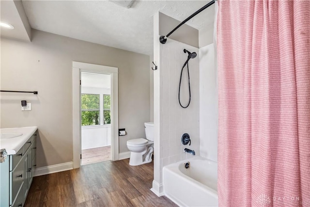 303 Hadley Ave, Oakwood, OH 45419 - full bathroom featuring toilet, vanity, shower / bath combo with shower curtain, wood finished floors, and baseboards
