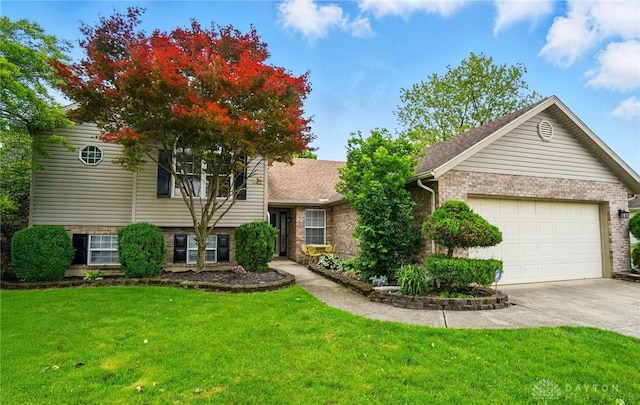 432 Applegate Rd, Englewood, OH 45322 - split level home featuring driveway, a front lawn, brick siding, and a garage
