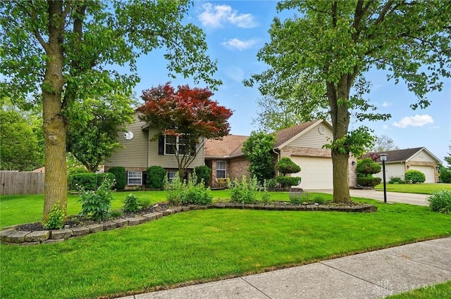 432 Applegate Rd, Englewood, OH 45322 - split level home with a garage, driveway, and brick siding