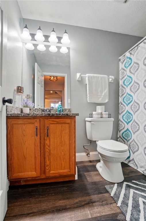 432 Applegate Rd, Englewood, OH 45322 - bathroom with wood finished floors, toilet, vanity, baseboards, and a shower with shower curtain