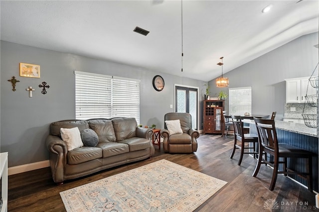 432 Applegate Rd, Englewood, OH 45322 - living room featuring lofted ceiling, dark wood-style floors, and baseboards