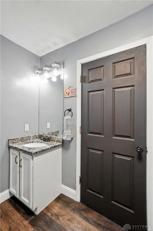 432 Applegate Rd, Englewood, OH 45322 - bathroom featuring baseboards, vanity, and wood finished floors