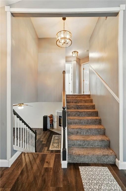 432 Applegate Rd, Englewood, OH 45322 - staircase with wood finished floors, baseboards, a chandelier, and a ceiling fan