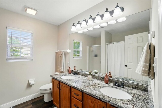 432 Applegate Rd, Englewood, OH 45322 - full bathroom featuring baseboards, wood finished floors, plenty of natural light, and a shower stall