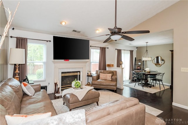 3008 Clearstream Way, Clayton, OH 45315 - living area featuring ceiling fan, healthy amount of natural light, baseboards, a glass covered fireplace, and vaulted ceiling