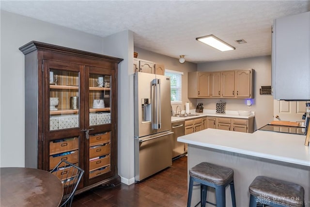 3008 Clearstream Way, Clayton, OH 45315 - kitchen featuring appliances with stainless steel finishes, a peninsula, a sink, dark wood-type flooring, and light countertops