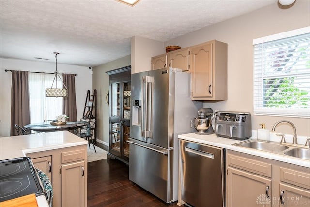 3008 Clearstream Way, Clayton, OH 45315 - kitchen featuring appliances with stainless steel finishes, light countertops, a sink, dark wood-style flooring, and a textured ceiling