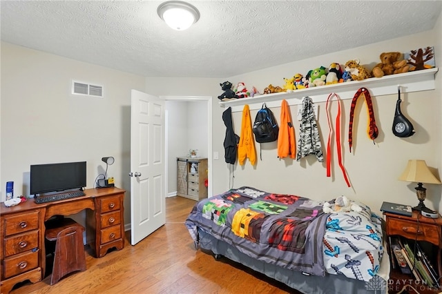 3835 Polo Trace Ct, Bellbrook, OH 45305 - bedroom featuring light wood-style floors and a textured ceiling