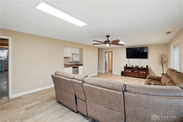 3835 Polo Trace Ct, Bellbrook, OH 45305 - living area featuring light wood finished floors, baseboards, and a ceiling fan