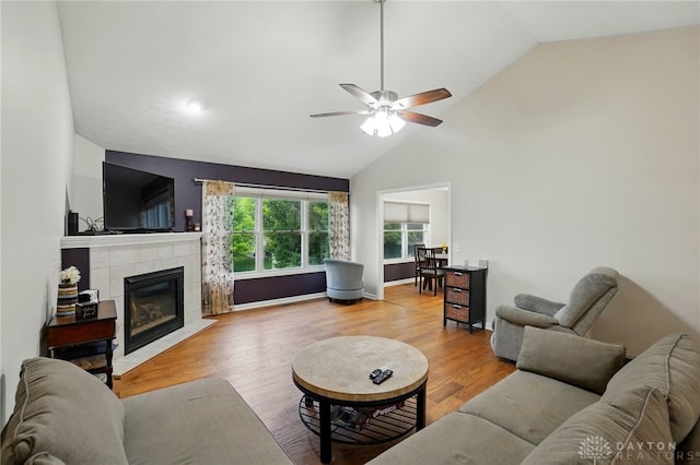 3835 Polo Trace Ct, Bellbrook, OH 45305 - living room with a tiled fireplace, a ceiling fan, wood finished floors, and high vaulted ceiling