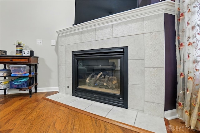 3835 Polo Trace Ct, Bellbrook, OH 45305 - detailed view of a tile fireplace, wood finished floors, and baseboards
