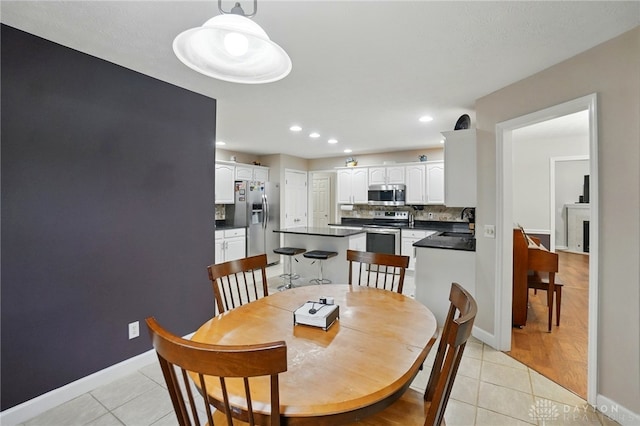 3835 Polo Trace Ct, Bellbrook, OH 45305 - dining area featuring light tile patterned flooring, recessed lighting, and baseboards