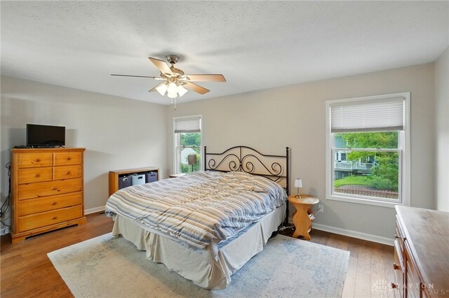 3835 Polo Trace Ct, Bellbrook, OH 45305 - bedroom with baseboards, wood finished floors, and a ceiling fan